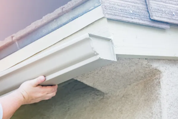 White gutter on house being installed